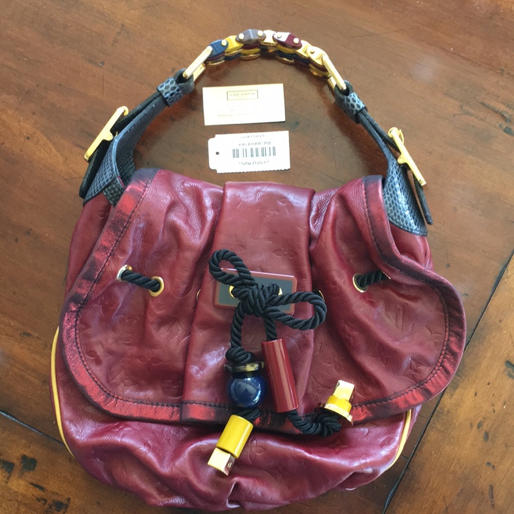 LOUIS VUITTON- Burgundy Kalahari hand bag.